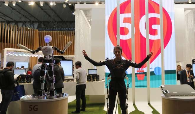 An exhibitor demonstrates 5G-related technology at last year’s Mobile World Congress in Barcelona. High-speed 5G can achieve theoretical speeds of up to 20 gigabits per second, compared to 1Gbps for 4G. Photo: Reuters