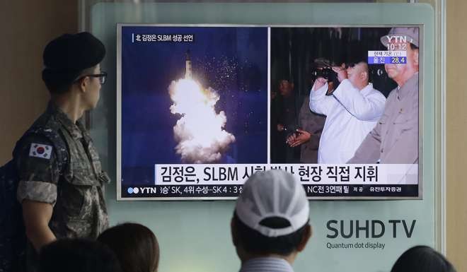 A South Korean soldier watches a TV news programme showing images published in North Korea's Rodong Sinmun newspaper of North Korea's ballistic missile launch. Photo: AP