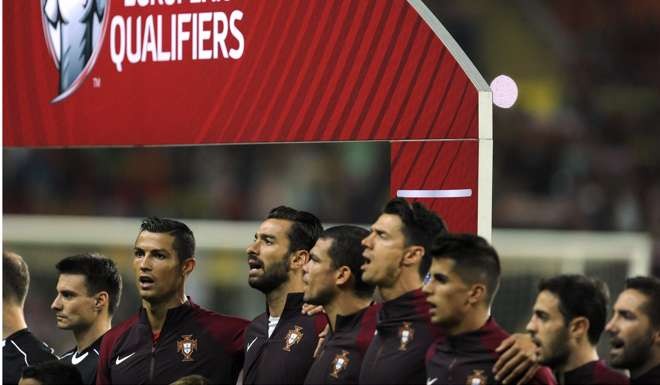 Cristiano Ronaldo (second left) and his teammates sing the Portuguese national anthem prior to their match against Andorra. Photo: AP