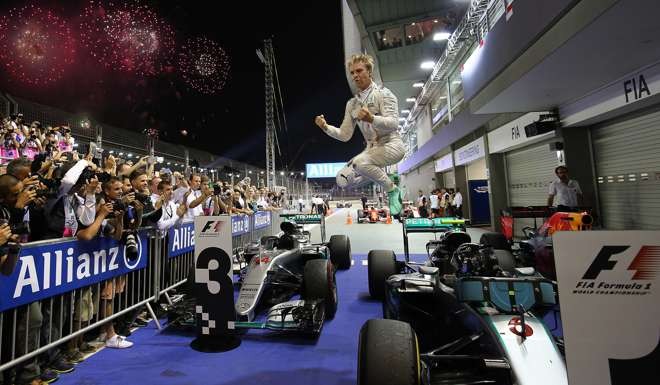 Mercedes driver Nico Rosberg of Germany jumps off his car as he celebrates winning the Singapore Formula One Grand Prix on September 18. Photo: AP