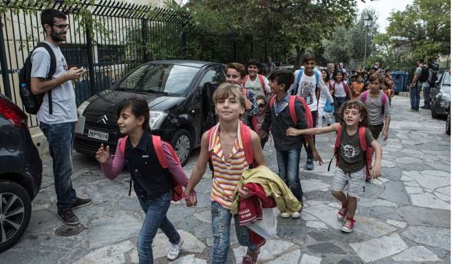 Refugee children enter a public elementary school in central Athens, Greece, on Monday. Photo: Xinhua