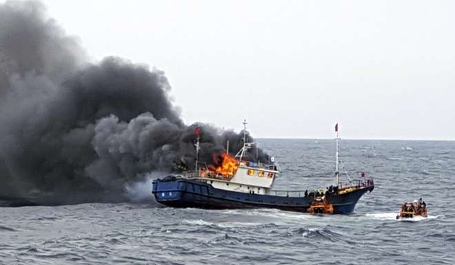 Three Chinese fishermen were killed last month in a fire that broke out on their boat when a South Korean coast guard crew trying to apprehend them for illegal fishing threw flash grenades into a room in which they were hiding, according to a South Korean official. Photo: AP