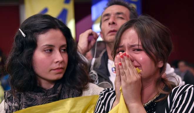 A woman cries at the results of a referendum to ratify a historic peace accord bringing an end to a 52-year war between the state and the communist FARC rebels. Photo: AFP