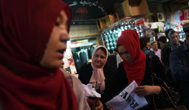 Muslim Uygur women shopping at a bazaar in Hotan, Xinjiang. Photo: AFP