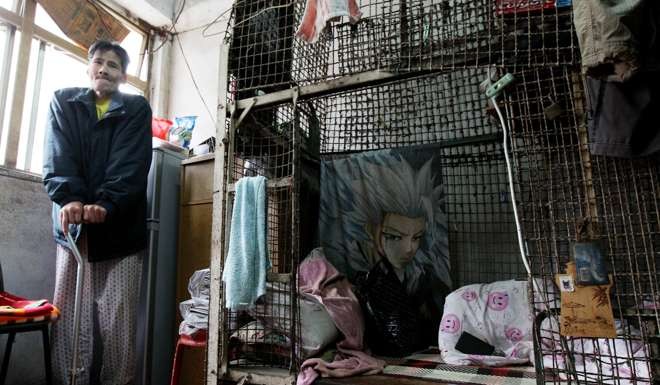 Lai Pui-ying, 61, share a room divided by cages with others. Photo: Nora Tam