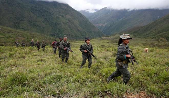 Members of the 51st Front of the Revolutionary Armed Forces of Colombia (FARC) patrol the remote mountains of Colombia. Photo: Reuters