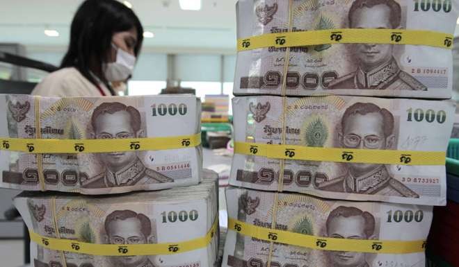 The Thai baht rallied on Friday morning, up 0.48 per cent to 35.23 against the US dollar, after the announcement that King Bhumibol Adulyadej had died. Photo: Reuters.