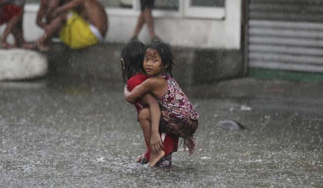 A flooded road in suburban Mandaluyong, east of Manila, Philippines. Photo: AP