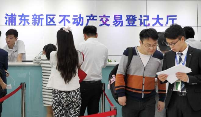 Shanghai residents line up at a property registration centre in Pudong. Photo: Xinhua