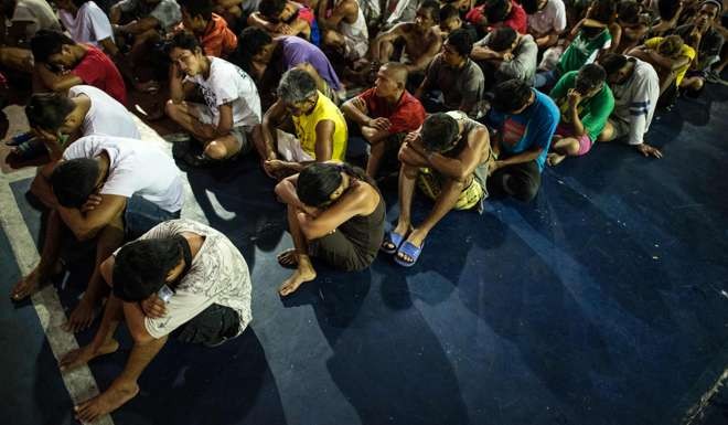 Alleged drug users are rounded up after a raid in a shanty community in Manila. America can and should help the Philippines set up rehabilitation centres for the many drug users who have surrendered to the government in the past few months. Photo: AFP