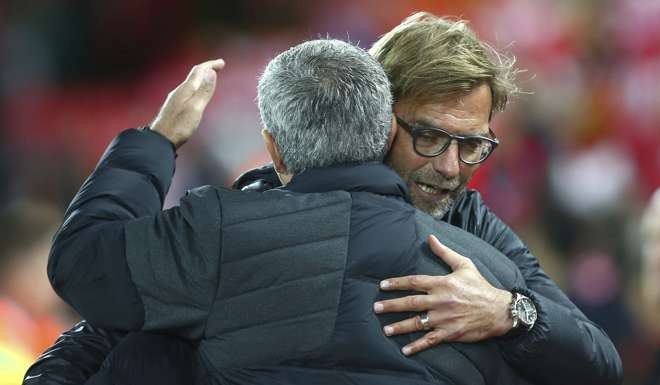 Liverpool's manager Juergen Klopp, right, hugs Manchester United's manager Jose Mourinho ahead of the English Premier League soccer match between Liverpool and Manchester United at Anfield stadium in Liverpool, England, Monday, Oct. 17, 2016. (AP Photo/Dave Thompson)