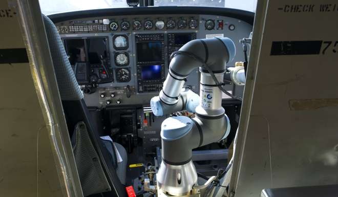 The Alias robot’s arm grasps the throttle of a Cessna Caravan aircraft at Manassas Airport in Virginia. Photo: AP