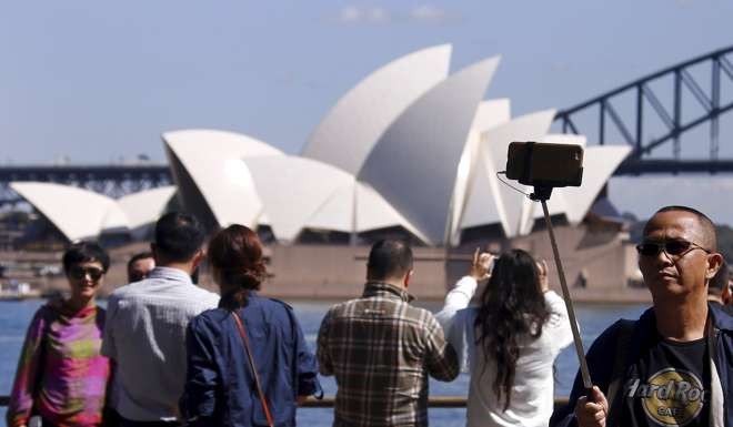 Chinese tourists in front of the Sydney Opera House. Photo: Reuters