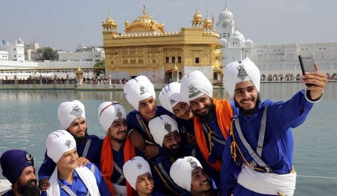 Fierce and friendly: selfie time at the Golden Temple, India, the holiest of Sikh shrines. Photo: EPA