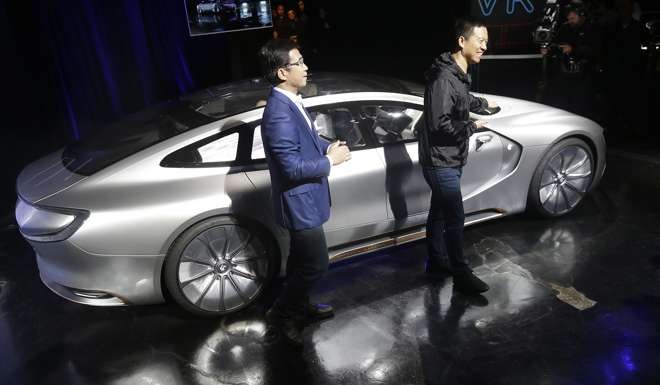 LeEco CEO Jia Yueting, right, and co-founder and SEE Plan Global Vice Chairman Lei Ding smile after unveiling the LeSEE car at an event in San Francisco. Photo: AP