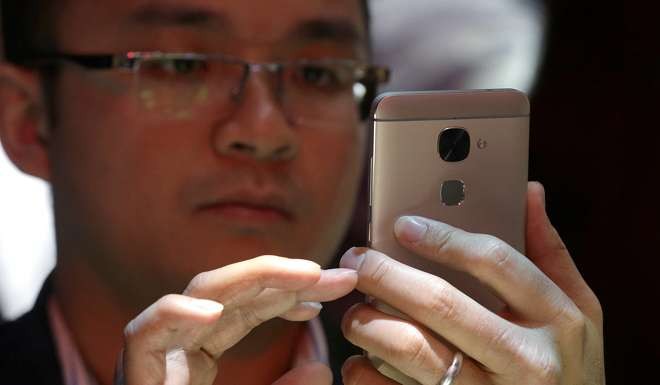 A man looks at LeEco's Le S3 phone on display at the company's event in San Francisco. Photo: AP