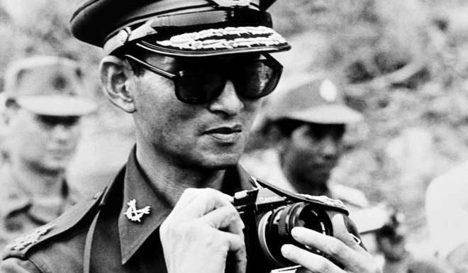 Bhumibol could often be seen wielding his camera. Photo: AFP