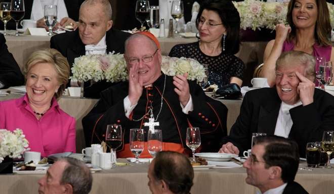 The rivals were separated by Cardinal Timothy Dolan, Archbishop of New York. Photo: AFP