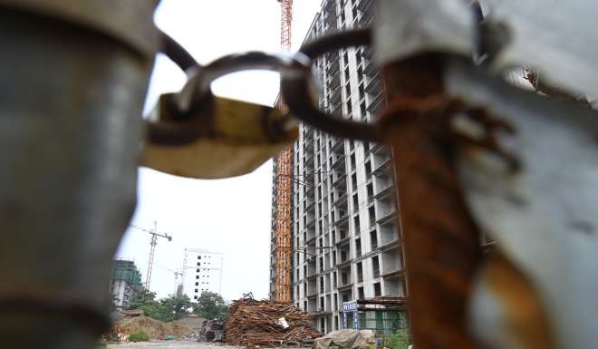 A construction site is locked up in Yuncheng, in Shanxi province, after work was suspended due to lack of funding, Photo by Simon Song