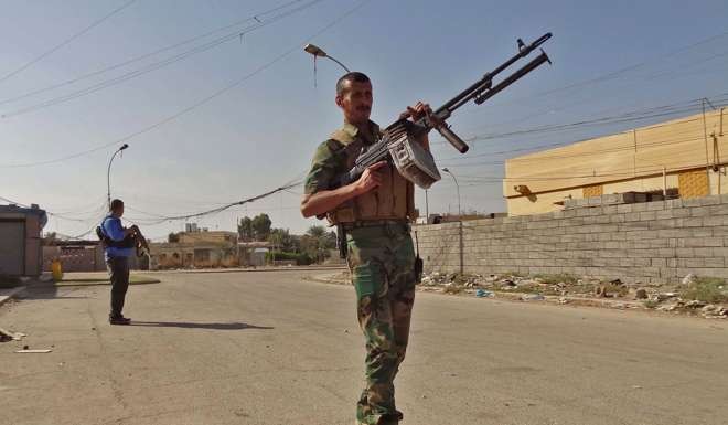 Iraqi police and Kurdish security forces deploy in the southern Domiz neighbourhood of Kirkuk. Photo: AFP