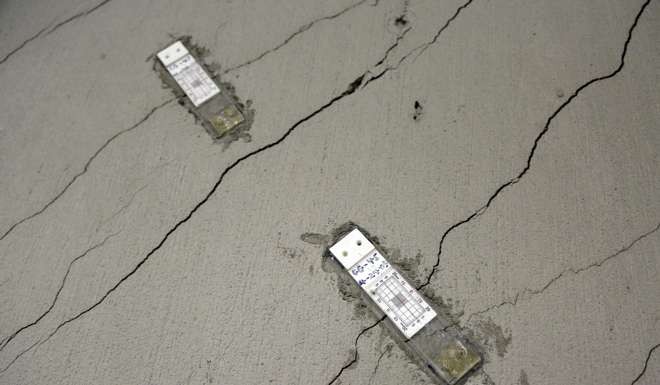 Stress gauges are placed along a wall with floor-to-ceiling cracks in the parking garage of the Millennium Tower in San Francisco.Photo: AP