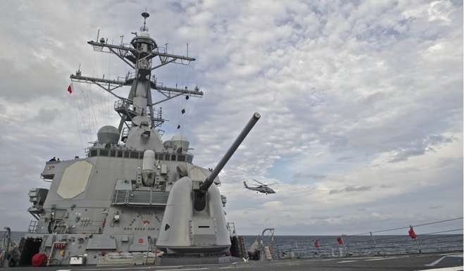 A helicopter takes off from the deck of the USS Decatur. Photo: AFP