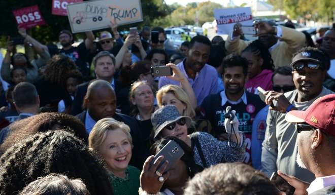 Democratic presidential nominee Hillary Clinton meets with voters during an impromptu stop at an early voting centre at Chavis Community Center in Raleigh, North Carolina. Photo: AFP