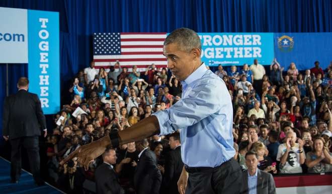 US President Barack Obama walks back onto the stage after shaking hands following his speech at a campaign event for Democratic presidential candidate Hillary Clinton in Las Vegas. Photo: AFP
