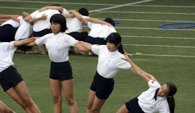 Japan's Princess Aiko (2nd R) performs group gymnastics with fellow students at the Gakushuin elementary school for her school's athletic festival in Tokyo in 2013. Photo: Reuters