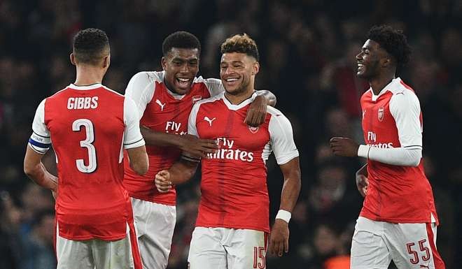 Arsenal midfielder Alex Oxlade-Chamberlain (second right) celebrates with teammates after scoring their second goal against Reading at the Emirates Stadium. Photo: AFP