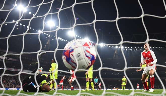 Alex Oxlade-Chamberlain scores their second goal. Photo: Reuters