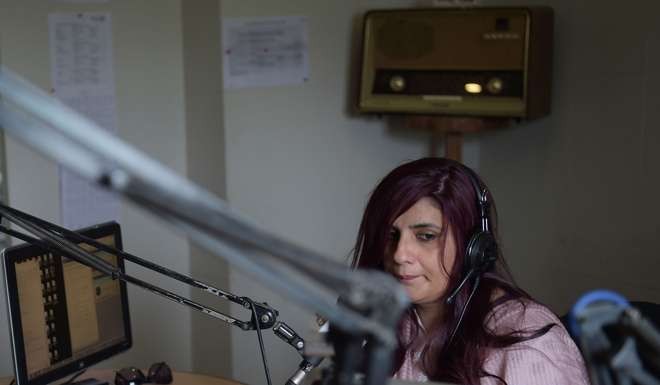Anila Ansari, a programme manager at Islamabad-based Power 99 FM radio, launches an on air 