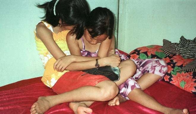 Vietnamese girls, aged eight and 10, in a brothel in Svay Pak, near Phnom Penh, in 2002, a time when underage brothels barely bothered to hide their business. Such flagrant activity is less prevalent now. Photo: Reuters