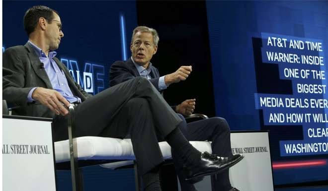 AT&T CEO Randall Stephenson (L) and Time Warner CEO Jeff Bewkes discuss their proposed deal at news conference in California on October 25. Photo: Reuters