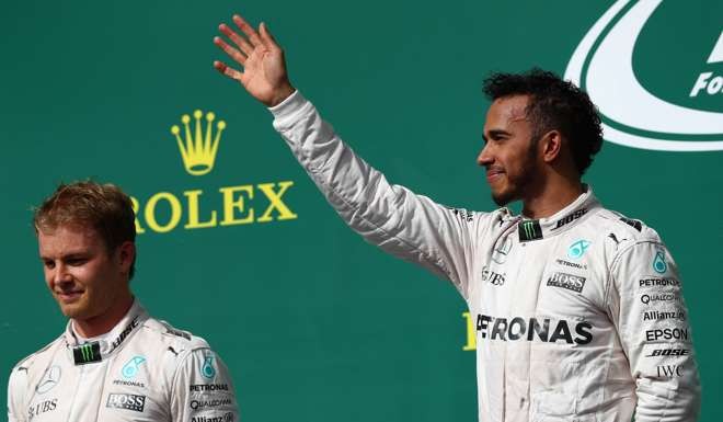 Lewis Hamilton celebrate after winning the United States Formula One Grand Prix ahead of teammate Nico Rosberg.