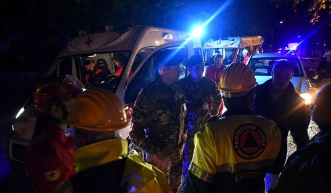 Rescuers gather in the village of Visso following a pair of powerful earthquakes which shook central Italy on Wednesday, knocking out power, closing a major highway and sending panicked residents into the streets. Photo: cchioni/ANSA via AP