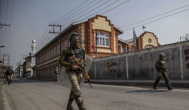 Indian paramilitary soldiers patrol during curfew in Srinagar, Indian controlled Kashmir. Photo: AP