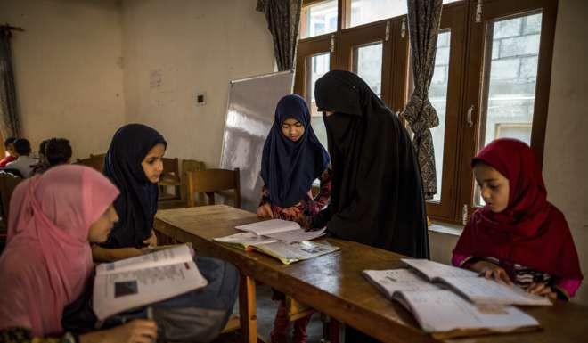Kashmiri girls study in an ad-hoc learning centre. Photo: AP