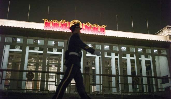 A paramilitary guard walks beside Tiananmen Square in Beijing as the plenum gets underway. Photo: AFP