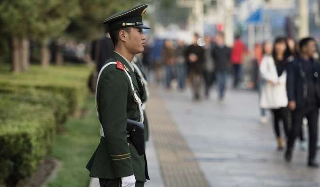 A paramilitary serviceman stands guard in Tiananmen Square in Beijing as the plenum gets underway. Photo: AFP