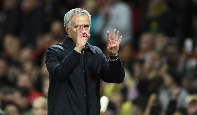 Manchester United's Portuguese manager Jose Mourinho gestures to supporters after the EFL (English Football League) Cup fourth round match between Manchester United and Manchester City at Old Trafford in Manchester, north west England on October 26, 2016. Manchester United won the game 1-0. / AFP PHOTO /