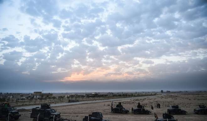 Members of the Iraqi Counter Terrorism Service (CTS) drive near the village of Bazwaya. Photo: AFP