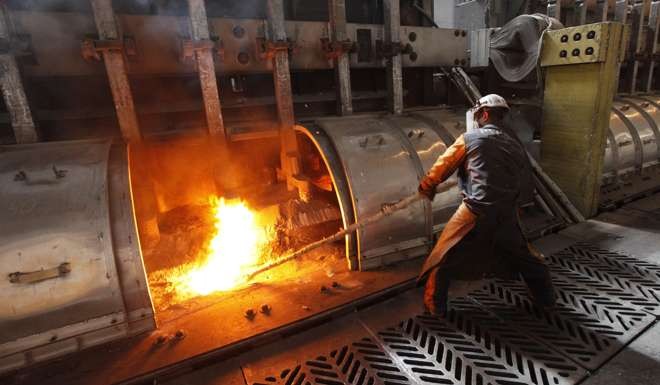 A worker operates a furnace at the Rusal Krasnoyarsk aluminium smelter in the Siberian city of Krasnoyarsk. Photo: Reuters