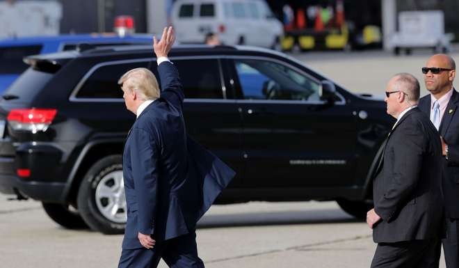 Republican presidential nominee Donald Trump waves after arriving at Detroit Metropolitan Wayne County Airport before heading to a campaign rally. Photo: AFP