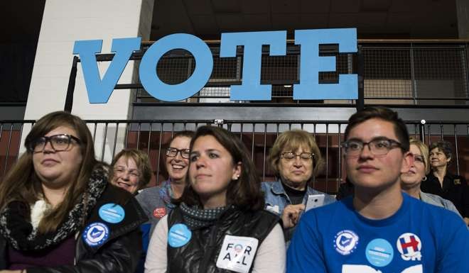 Attendees wait for the start of a campaign event with Hillary Clinton, 2016 Democratic presidential nominee, in Kent, Ohio. Photo: Bloomberg