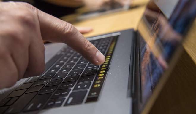 A user tries out the Touch Bar on the new MacBook Pro. Photo: Bloomberg