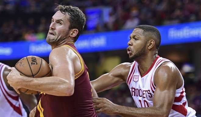 Cleveland Cavaliers forward Kevin Love (0) spins around Houston Rockets Eric Gordon (10) in the second half of an NBA basketball game Tuesday, Nov. 1, 2016, in Cleveland. The Cavaliers won 128-120. (AP Photo/DavidDermer)