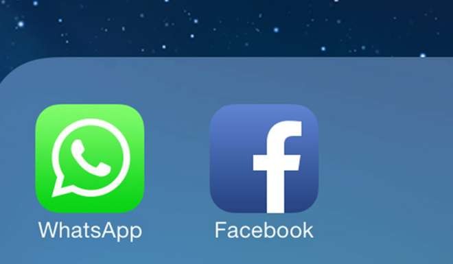 The Facebook and WhatsApp app icons displayed on an iPhone. Photo: EPA