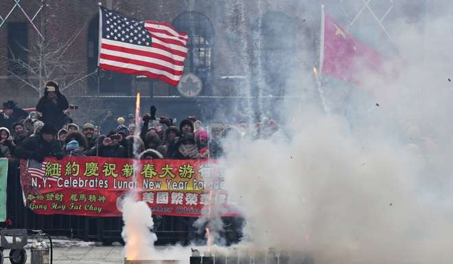 A crowd of New York revellers celebrate the Chinese Lunar New year by setting off firecrackers in Sara Delano Roosevelt Park on February 19, 2015
