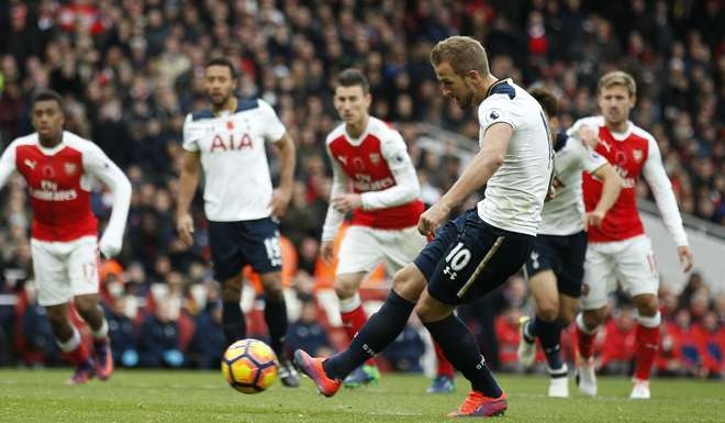 Tottenham’s Harry Kane scores from the penalty spot against Arsenal. Photo: Reuters